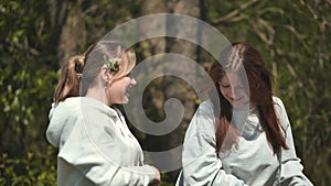 Schoolgirls relaxing at a picnic. Having fun and dancing.