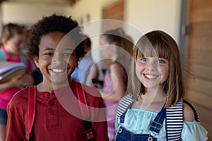 Schoolgirls standing in an outdoor corridor at elementary school