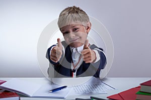 Schoolkid showing thumbs up photo