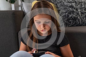Schoolkid spending too much time on mobile device photo