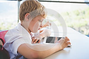 Schoolkid using digital tablet in classroom