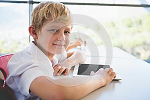 Schoolkid using digital tablet in classroom