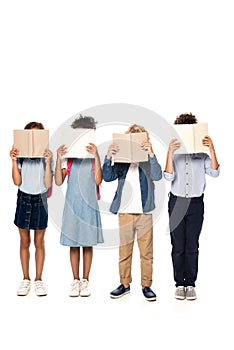 Schoolkids covering faces with books isolated