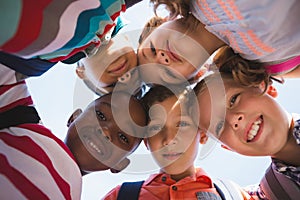 Schoolkids forming huddle in campus