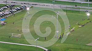 Schoolkids training in soccer game on school football stadium in sports park in North Port, Florida