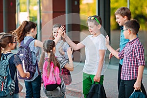 Schoolmates go to school. Students greet each other. photo