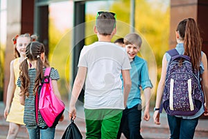 Schoolmates go to school. Students greet each other.