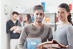 Schoolmates posing with books