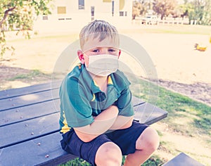 Schools closures Coronavirus lockdown. Bored school kid alone in playground feeling sad and lonely