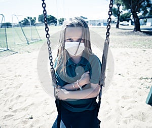 Schools closures Coronavirus lockdown. Bored school kid alone in playground feeling sad and lonely