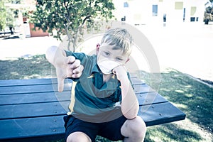 Schools closures Coronavirus lockdown. Bored school kid alone in playground feeling sad and lonely