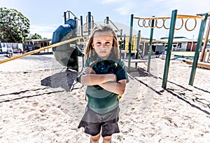 Schools closures Coronavirus lockdown. Bored school kid alone in playground feeling sad and lonely