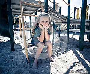 Schools closures Coronavirus lockdown. Bored school kid alone in playground feeling sad and lonely