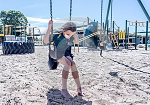 Schools closures Coronavirus lockdown. Bored school kid alone in playground feeling sad and lonely