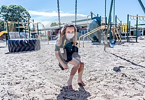 Schools closures Coronavirus lockdown. Bored school kid alone in playground feeling sad and lonely