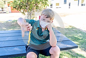 Schools closures Coronavirus lockdown. Bored school kid alone in playground feeling sad and lonely