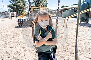 Schools closures Coronavirus lockdown. Bored school kid alone in playground feeling sad and lonely