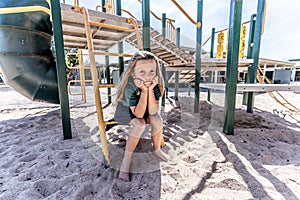 Schools closures Coronavirus lockdown. Bored school kid alone in playground feeling sad and lonely