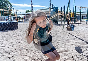 Schools closures Coronavirus lockdown. Bored school kid alone in playground feeling sad and lonely