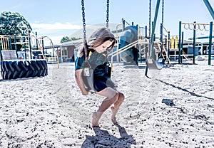 Schools closures Coronavirus lockdown. Bored school kid alone in playground feeling sad and lonely