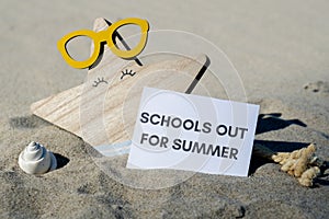 SCHOOLS OUT FOR SUMMER text on paper greeting card on background of funny starfish in glasses summer vacation decor