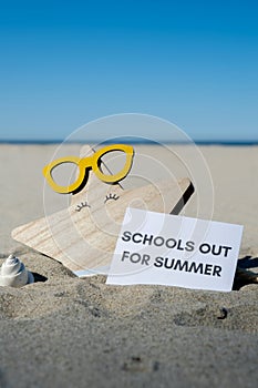 SCHOOLS OUT FOR SUMMER text on paper greeting card on background of funny starfish in glasses summer vacation decor