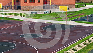 Schoolyard with a playground for basketball.