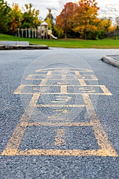 School yard with hopscotch and playground for elementary students in evening in fall season