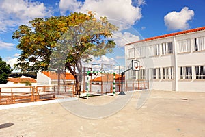 Schoolyard of a public primary school with basketball court in holiday