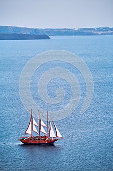 Schooner vessel ship boat in Aegean sea near Santorini island with tourists going to sunset viewpoint