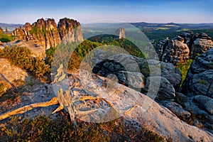 Schrammsteine, beautiful evening view over sandstone cliff into deep misty valley in Saxony Switzerland, evening background, the f