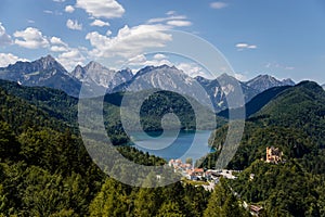 Schwangau, Bavaria, Germany, 3 July 2022: view from castle Neuschwanstein in Alps, lake Alpsee and Schwansee near small village,