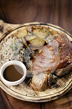 SCHWEINSHAXE traditional german pork knuckle with sauerkraut and potatoes meal