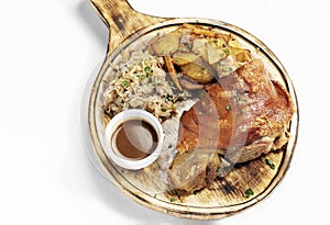 SCHWEINSHAXE traditional german pork knuckle with sauerkraut and potatoes meal