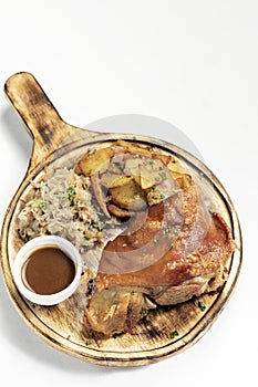 SCHWEINSHAXE traditional german pork knuckle with sauerkraut and potatoes meal