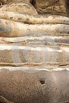 Sci-fi other worldly dystopian background of folds of rounded cement concrete neutral shades of black, white, beige, tan