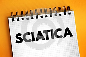 Sciatica - pain, weakness, numbness, or tingling in the leg, text concept on notepad