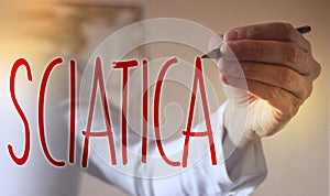 Sciatica word Doctor writes with red marker. Selective focus. Medical healthcare concept photo