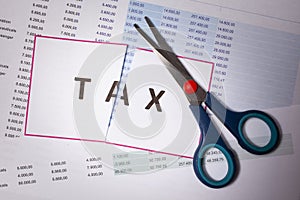 Sciccors cut paper with word Tax