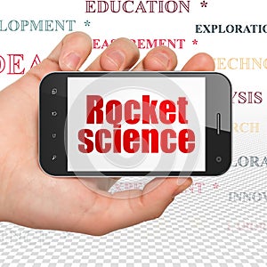 Science concept: Hand Holding Smartphone with Rocket Science on display