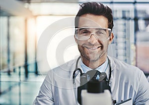 Science is about discovering new ways for a better life. Portrait of a young handsome male scientist working in a lab