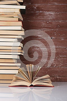 Science and education -  Open book on a group pile books and wooden. Reflection