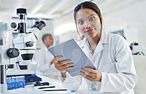 Science is an essential element in daily life. Portrait of a young scientist using a digital tablet in a lab.