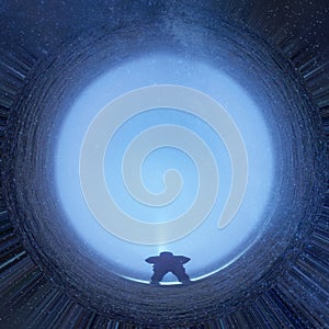 A science fiction concept. A man standing looking at a glowing portal with stars in the night sky