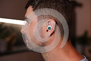 Science fiction style concept where a man has an eyeball inside his ear