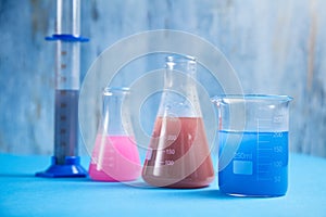 Science glassware with colored liquid in chemistry laboratory