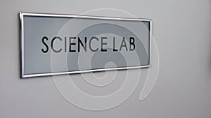 Science lab door, hand knocking close up, chemical experiments, biology research