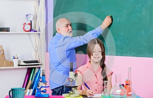 Science lab. small girl with man tutor study chemistry. mature teacher of biology. Pupil girl in school lab. science