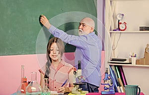 Science lab. small girl with man tutor study chemistry. mature teacher of biology. Pupil girl in school lab. science