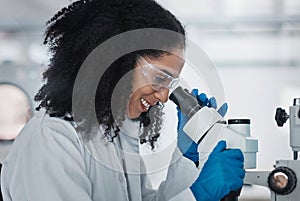 Science, microscope and innovation with a doctor black woman at work in a lab for research or development. Medical